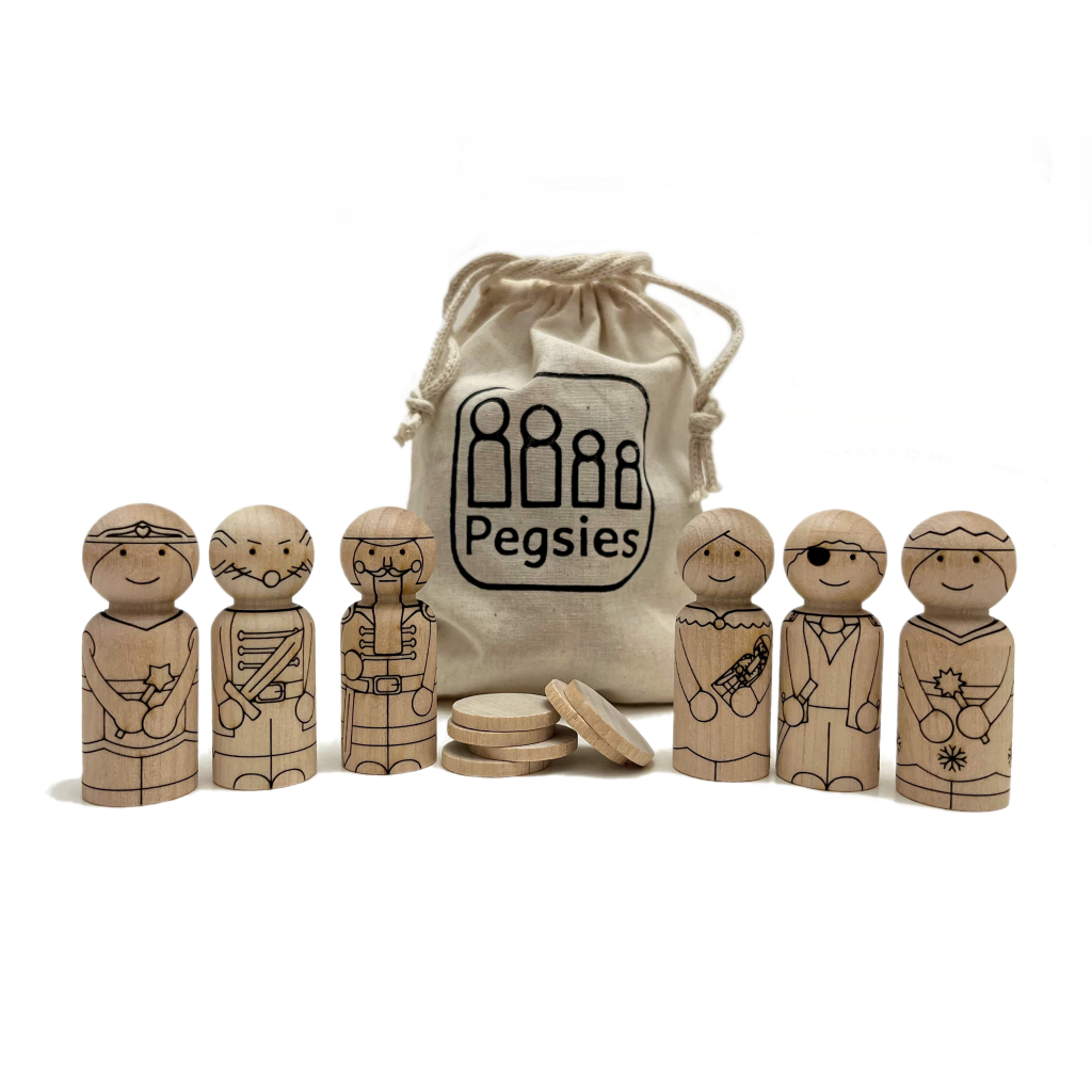 Six peg dolls made from birch wood laser etched with Christmas Nutcracker characters including Drosselmeyer, Clara, Nutcracker, Snow Queen, Sugar Plum Fairy, and Mouse King. Includes muslin cotton pouch and five birch tokens to test coloring tools.